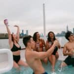 a group of people celebrating in hot tub boat in NYC