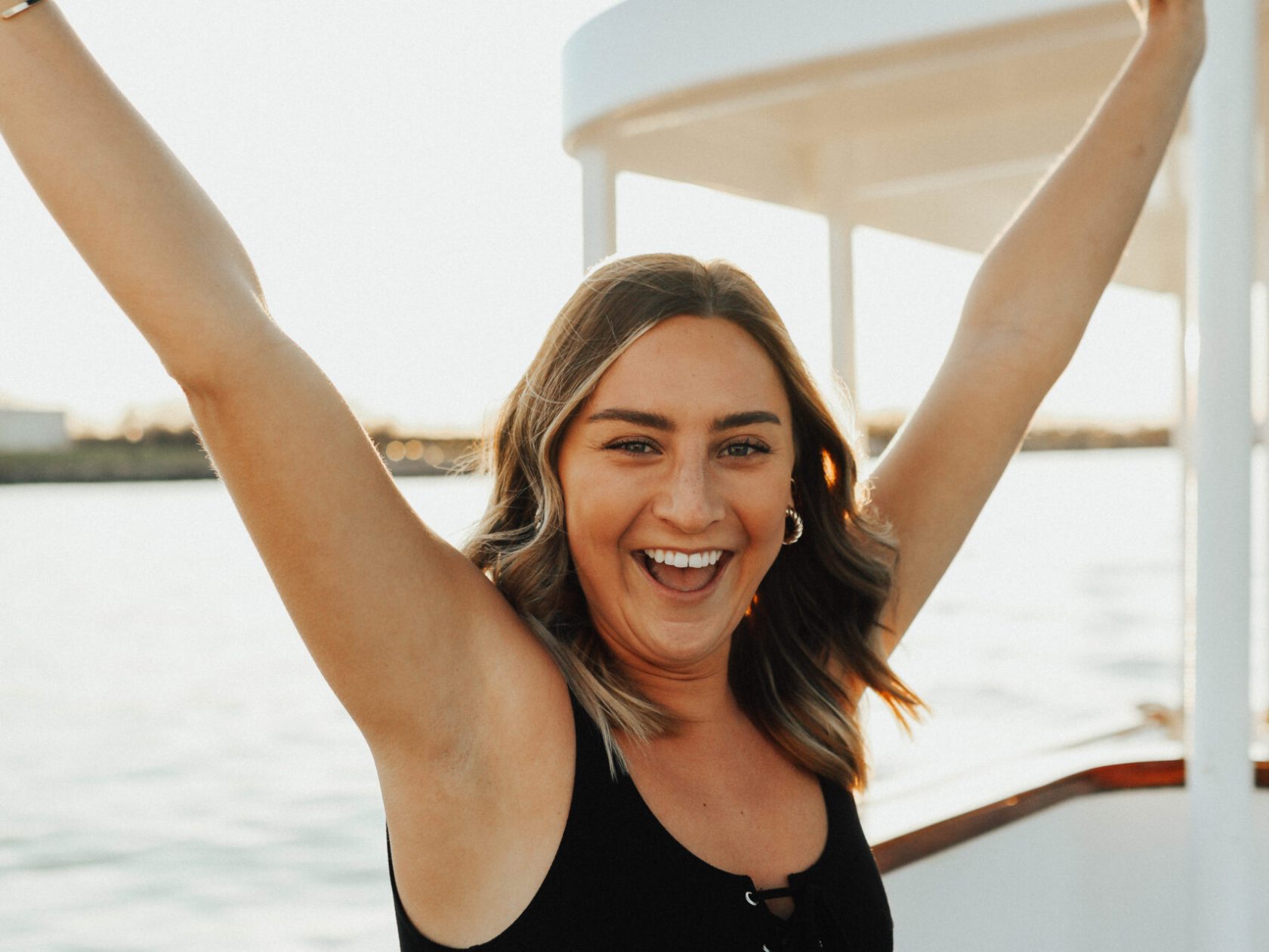a woman standing in front of water