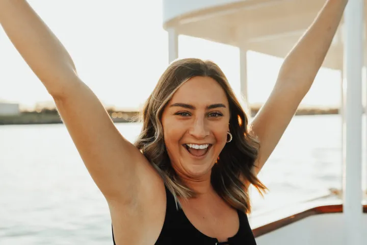 a woman standing in front of water