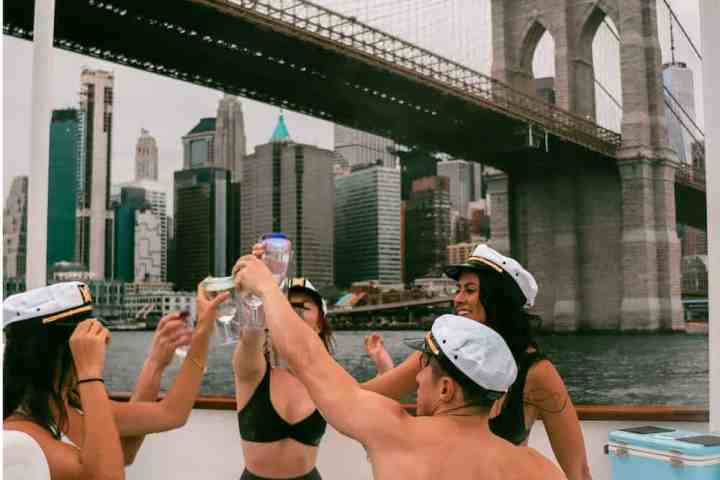 a woman drinking water in a city