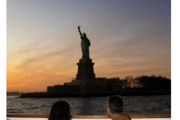 a man sitting in front of a body of water