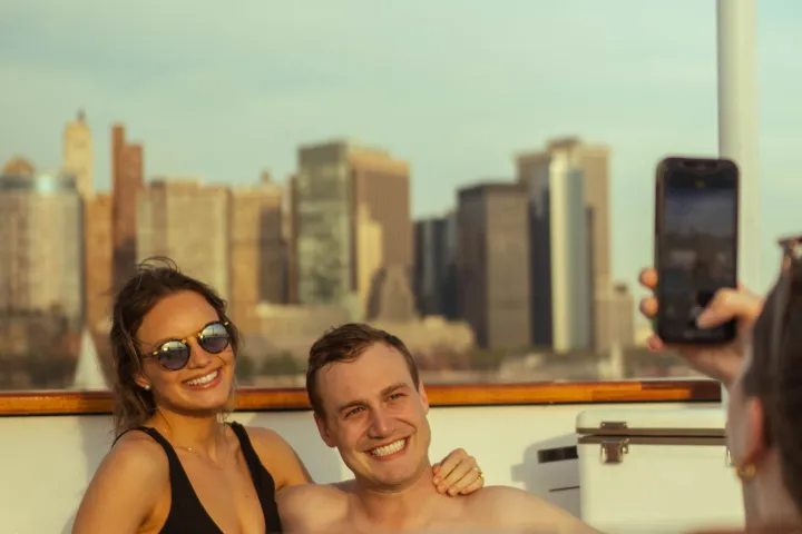 a group of people standing in front of a mirror posing for the camera