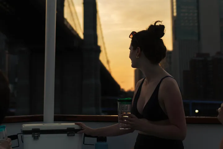 a person standing on hot tub boat in NYC