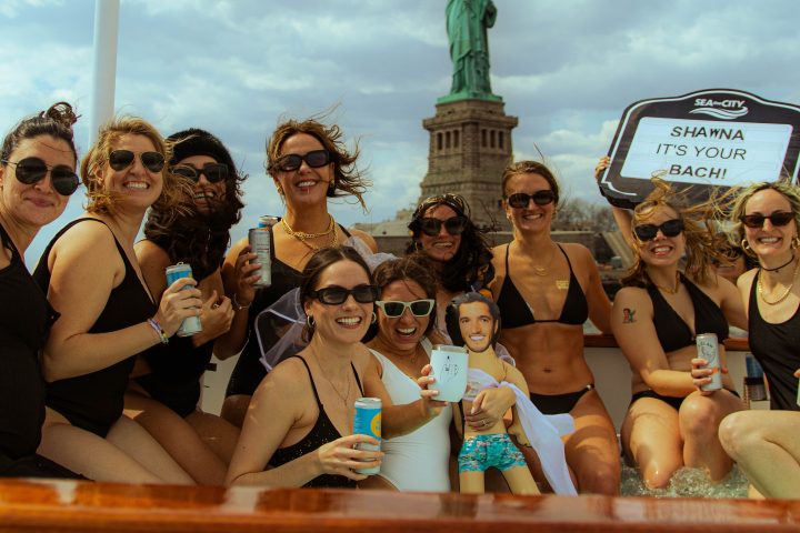 people posing for the camera in NYC Hot Tub Boat